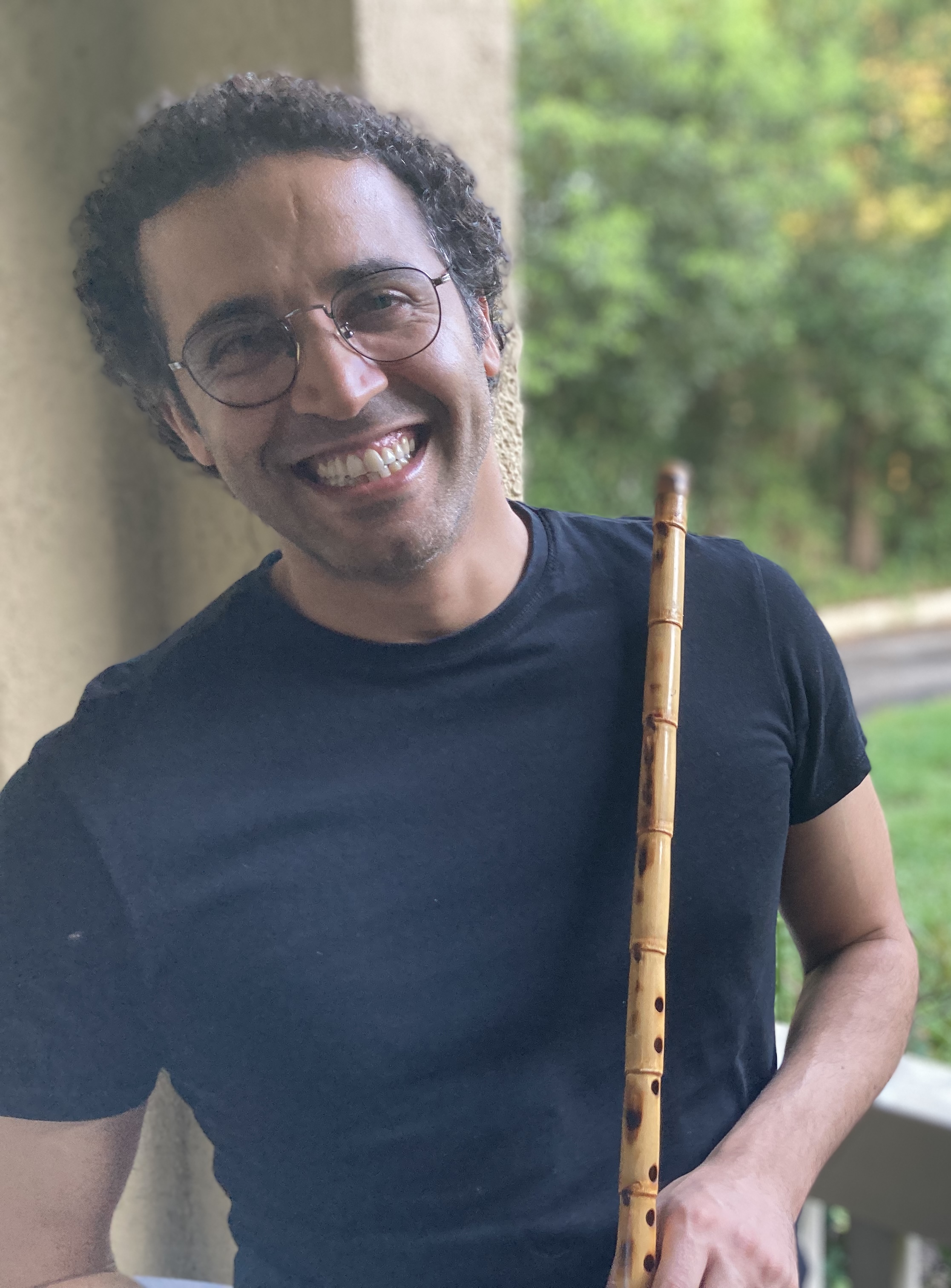 Fadi Al-Ghawanmeh holding a nay flute outdoors